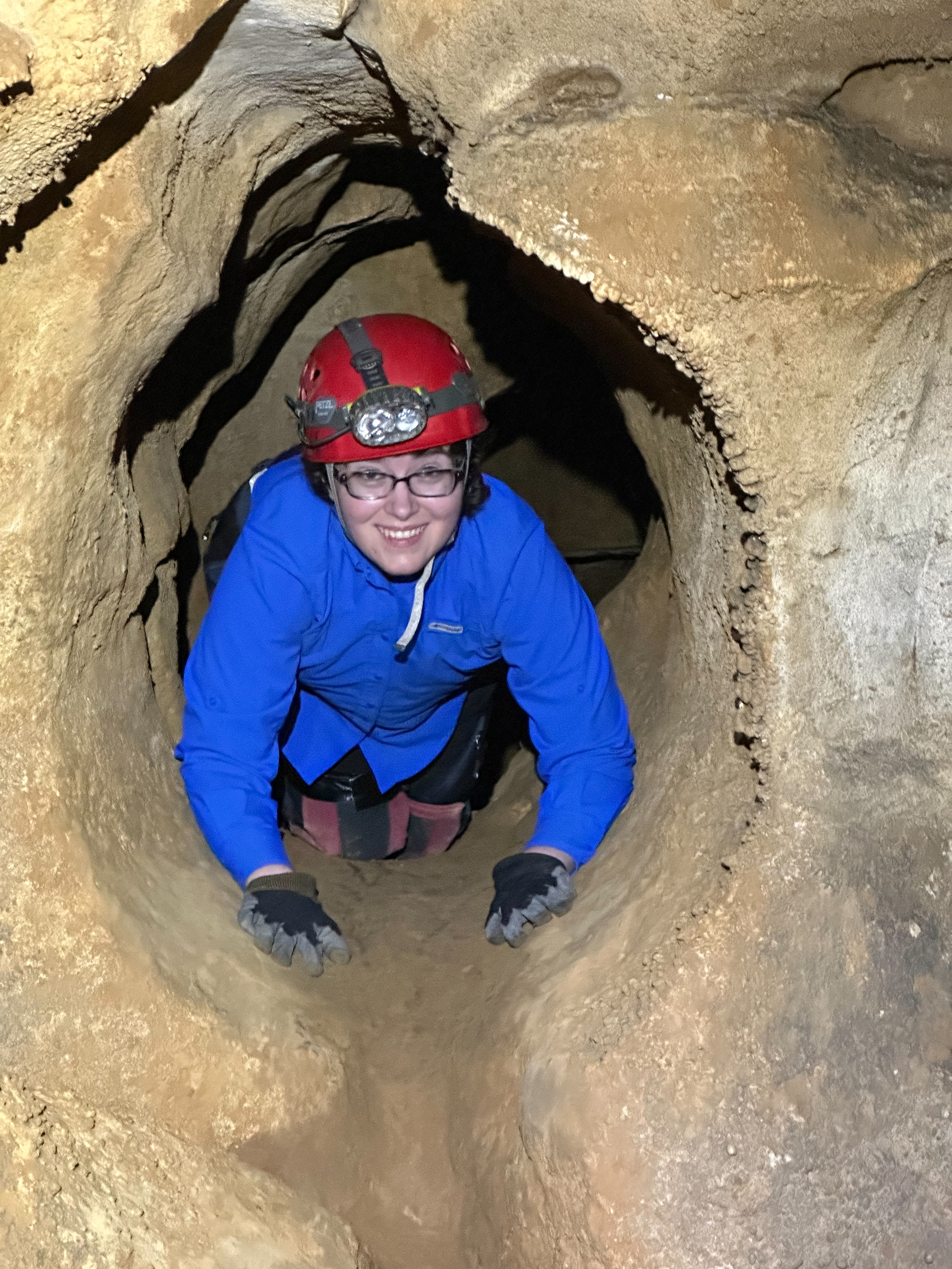 An image of Miranda McKibben in a cave tunnel